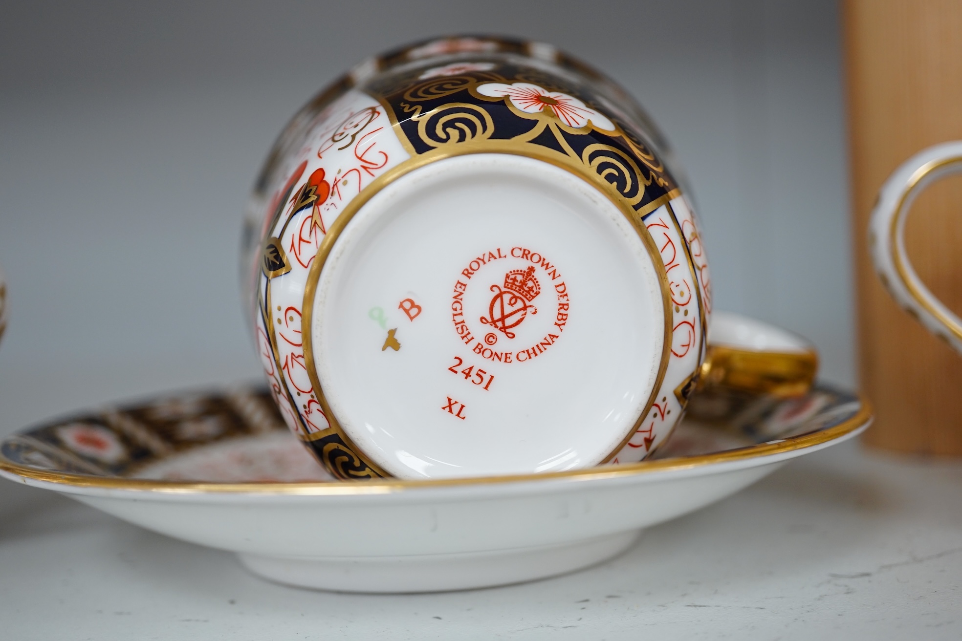 Two Royal Crown Derby sugar bowls, and a cup and saucer, largest 9cm high. Condition - good.